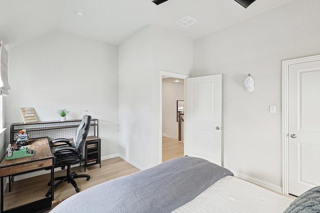 bedroom with light hardwood / wood-style floors and vaulted ceiling