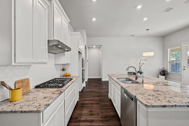 kitchen with a kitchen island with sink, appliances with stainless steel finishes, white cabinets, and a sink