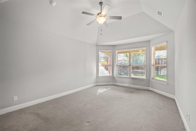 empty room with lofted ceiling, carpet floors, a wealth of natural light, and baseboards