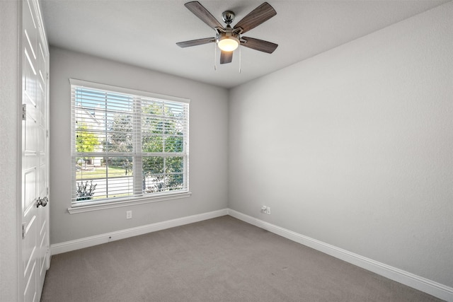 unfurnished room with ceiling fan, baseboards, and carpet flooring