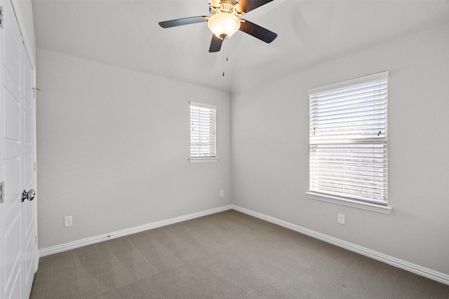 empty room with carpet floors, ceiling fan, and baseboards