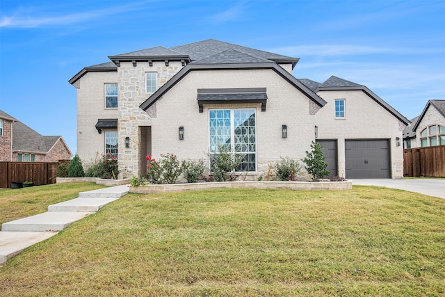 view of front of home featuring a front yard and a garage