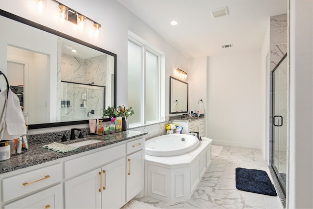 bathroom featuring vanity, independent shower and bath, and a healthy amount of sunlight