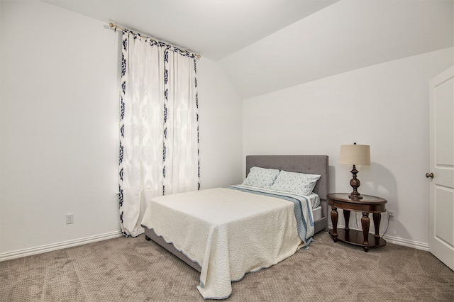 bedroom featuring light carpet and lofted ceiling