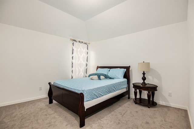 bedroom featuring lofted ceiling and light colored carpet