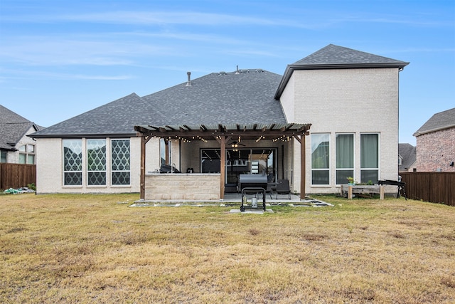 rear view of house with a yard, a patio, and a pergola