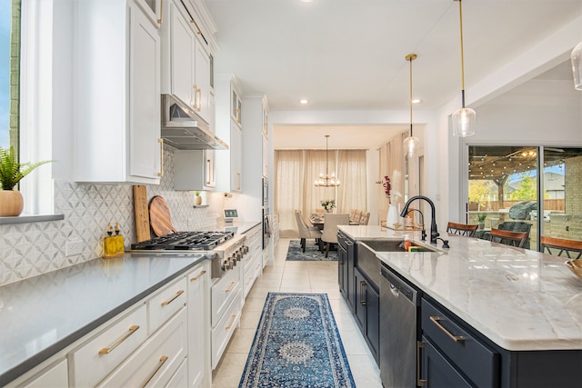 kitchen with a large island, appliances with stainless steel finishes, white cabinetry, pendant lighting, and sink