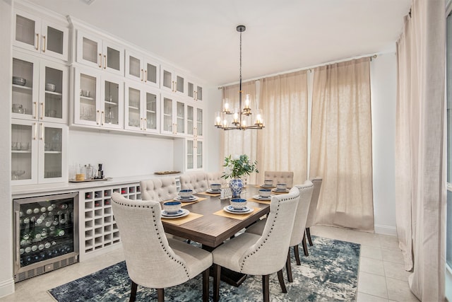 dining room featuring a chandelier, light tile patterned floors, and beverage cooler