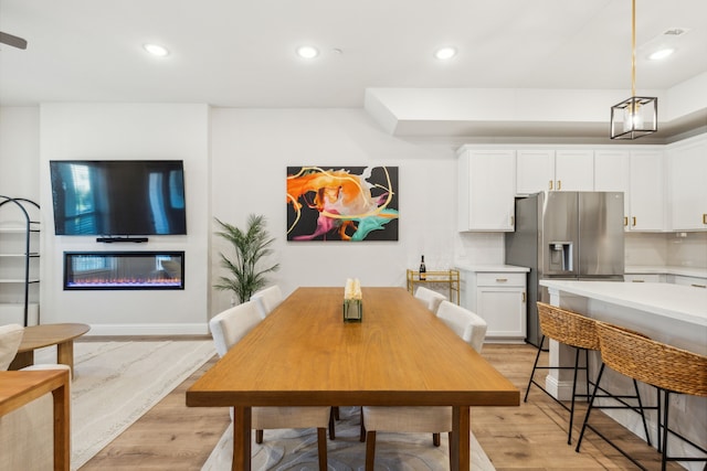 dining space with light hardwood / wood-style floors