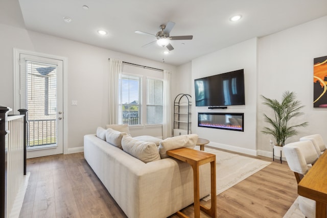 living room featuring ceiling fan and wood-type flooring