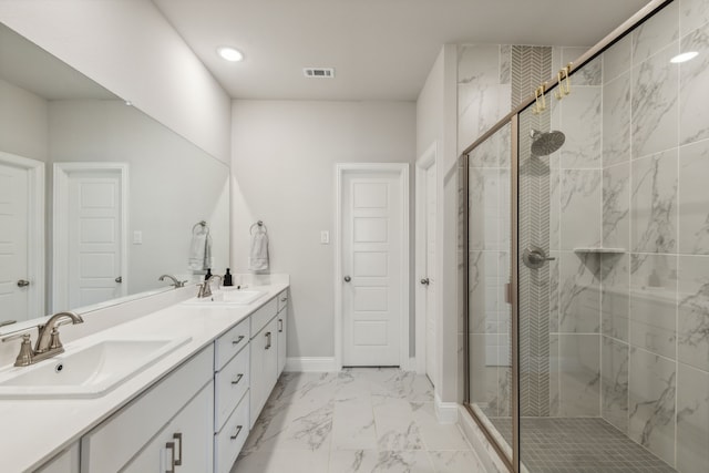 bathroom featuring a shower with shower door and vanity