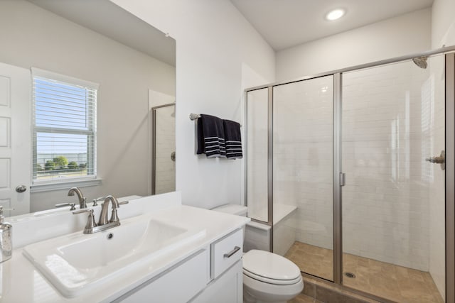 bathroom featuring walk in shower, vanity, and toilet