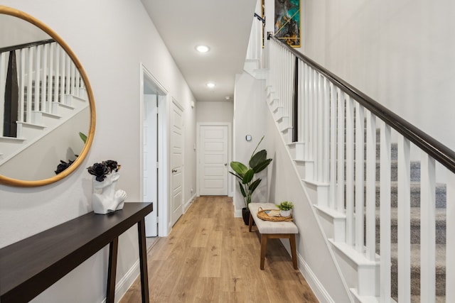 hallway with light hardwood / wood-style floors