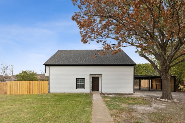 back of property featuring a lawn