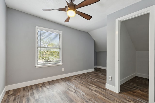 additional living space featuring ceiling fan, dark hardwood / wood-style flooring, and vaulted ceiling