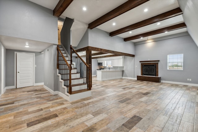 unfurnished living room featuring beamed ceiling