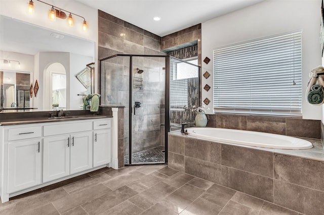 bathroom featuring vanity and plus walk in shower