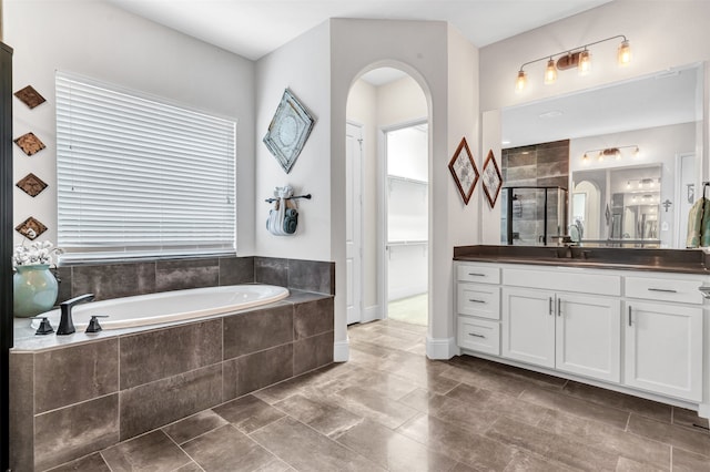 bathroom featuring vanity and plus walk in shower