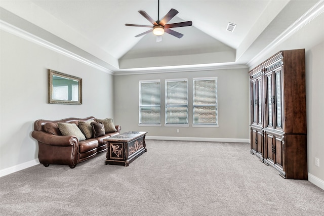 living room with lofted ceiling, crown molding, light colored carpet, and ceiling fan