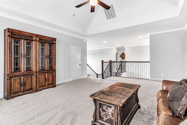 living room featuring ceiling fan, ornamental molding, and carpet floors