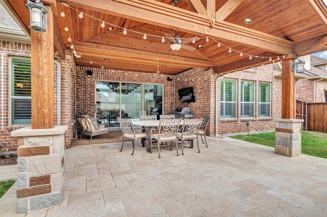 view of patio with area for grilling and ceiling fan