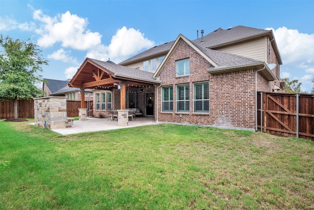 back of house featuring a yard, ceiling fan, and a patio area