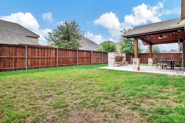 view of yard with a patio area and ceiling fan