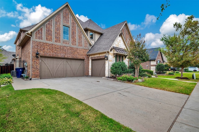 view of front of property with a front yard and a garage