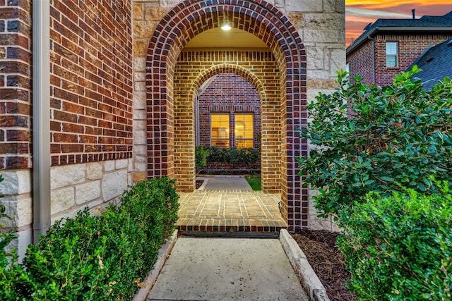 view of exterior entry at dusk