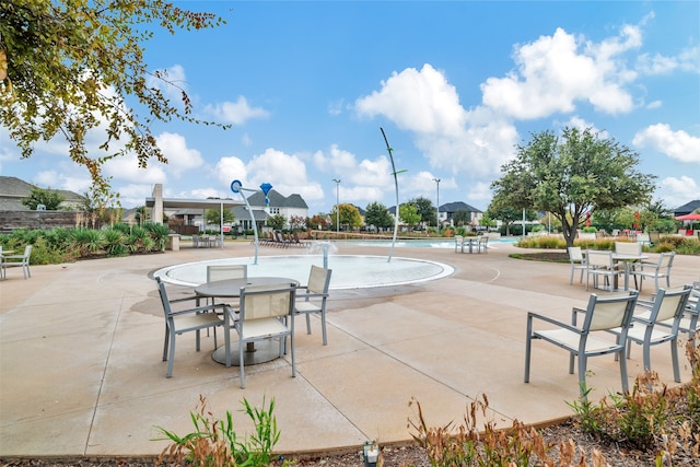 exterior space with pool water feature and a community pool