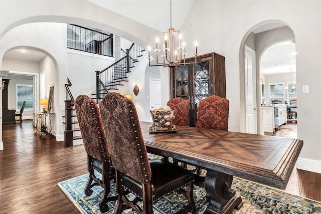 dining space with an inviting chandelier and dark hardwood / wood-style floors