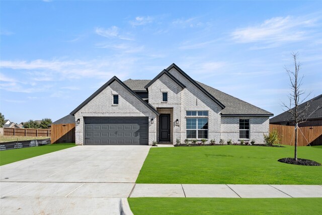 french country inspired facade with a front yard and a garage