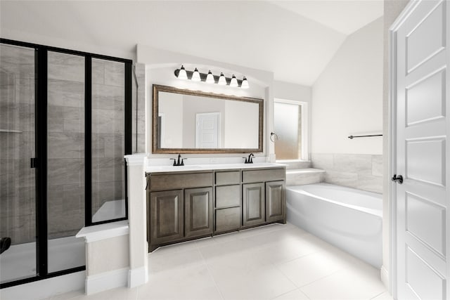 bathroom with tile patterned flooring, vanity, vaulted ceiling, and separate shower and tub