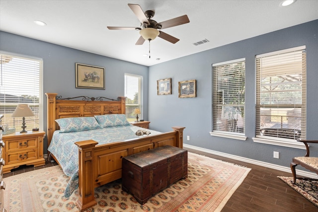 bedroom with dark hardwood / wood-style floors and ceiling fan