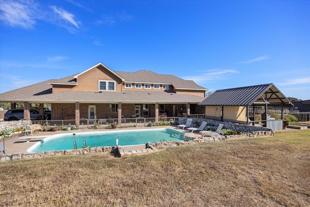 view of pool with a yard, a diving board, and a patio