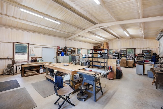 interior space featuring vaulted ceiling with beams, a workshop area, and plenty of natural light