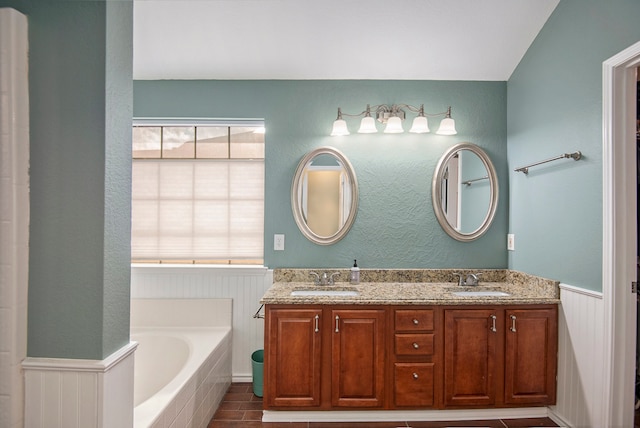 bathroom featuring a tub, vanity, and tile patterned floors