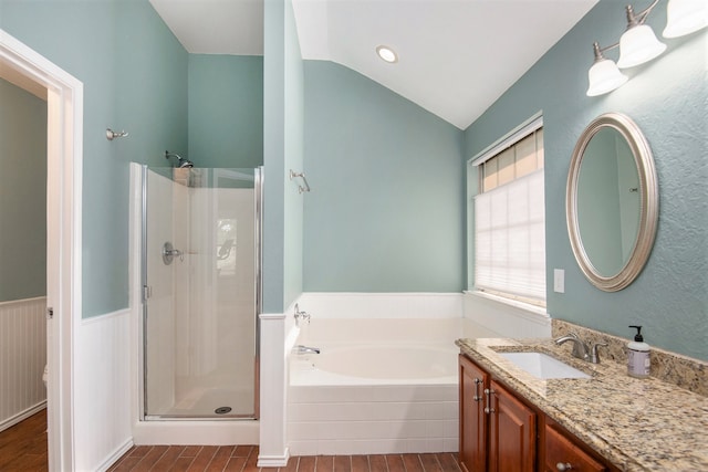 bathroom with vanity, shower with separate bathtub, lofted ceiling, and hardwood / wood-style floors