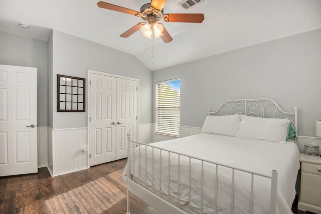 bedroom featuring dark wood-type flooring, ceiling fan, a closet, and lofted ceiling