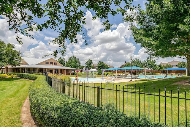 view of home's community featuring a lawn and a swimming pool