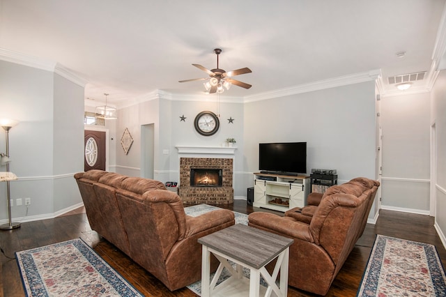 living room featuring a fireplace, dark hardwood / wood-style floors, crown molding, and ceiling fan