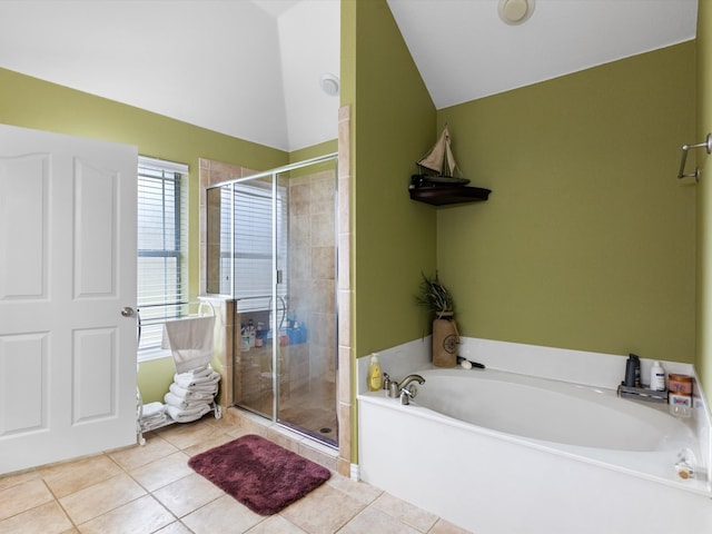 bathroom featuring tile patterned floors, separate shower and tub, and vaulted ceiling