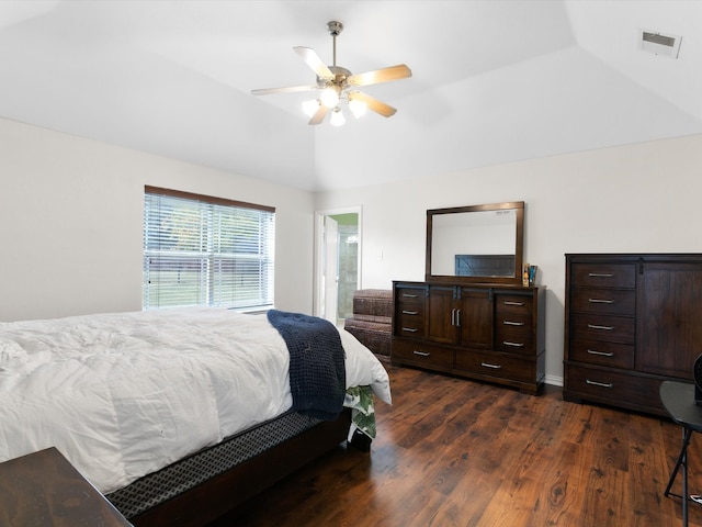 bedroom with ceiling fan, vaulted ceiling, dark hardwood / wood-style floors, and ensuite bathroom