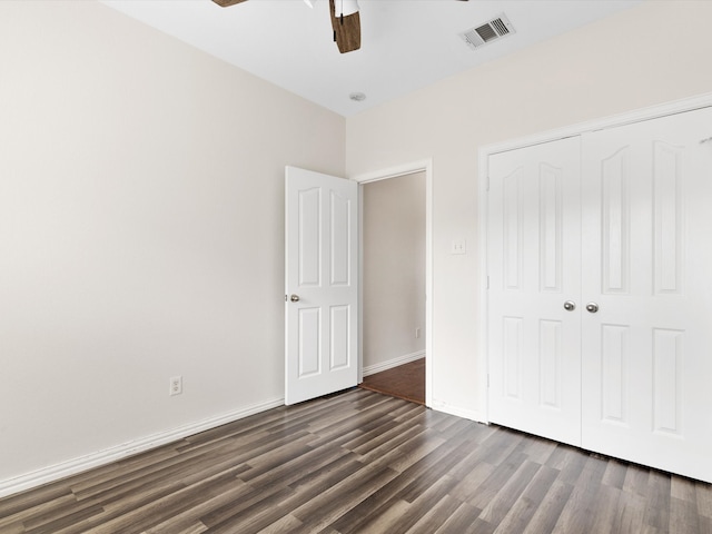 unfurnished bedroom featuring a closet, ceiling fan, and dark hardwood / wood-style floors