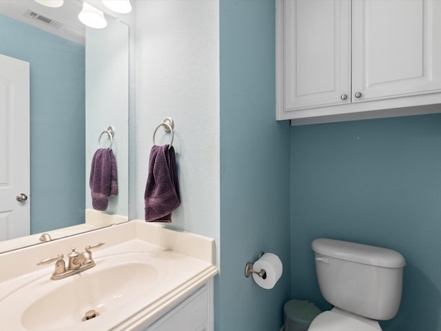 bathroom featuring toilet and vanity