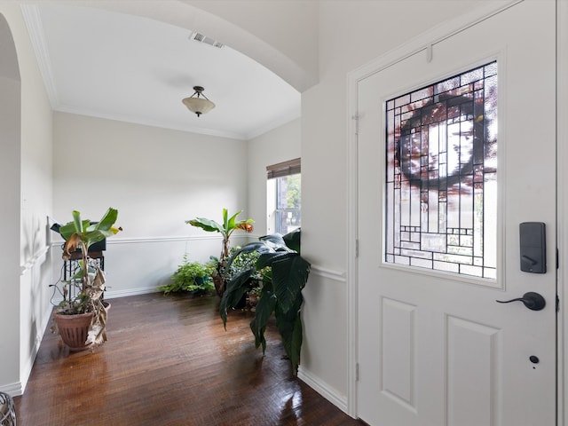 foyer entrance featuring ornamental molding and dark hardwood / wood-style floors