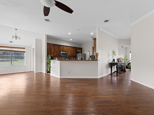 living room with ornamental molding, dark hardwood / wood-style floors, and ceiling fan with notable chandelier