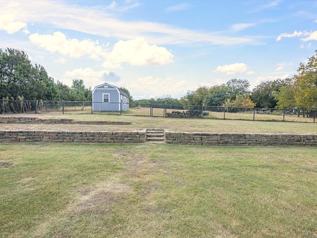 view of yard featuring a storage shed and a rural view