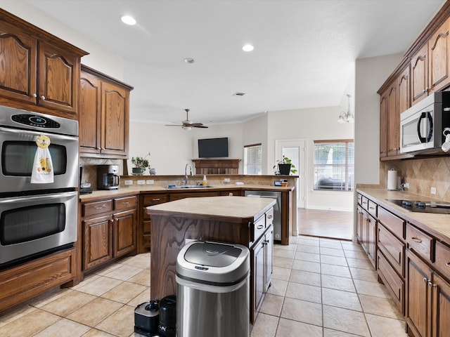 kitchen featuring a kitchen island, stainless steel appliances, light tile patterned floors, and tasteful backsplash