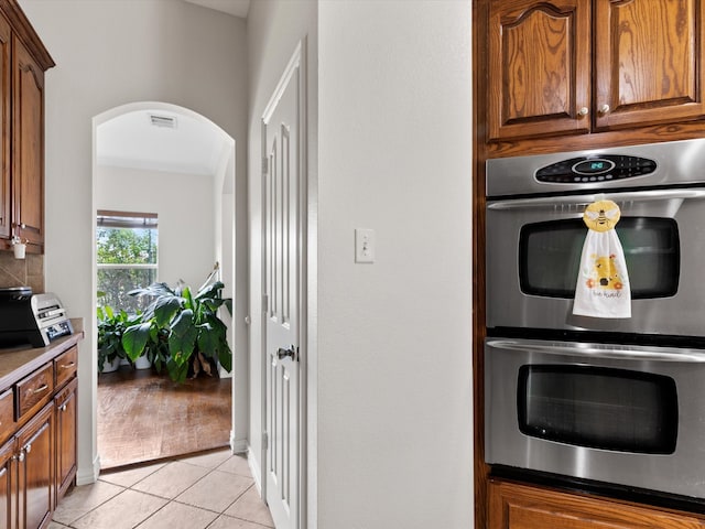 kitchen with light hardwood / wood-style floors and double oven